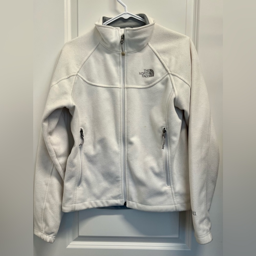 Women’s North Face white zip up fleece coat.
